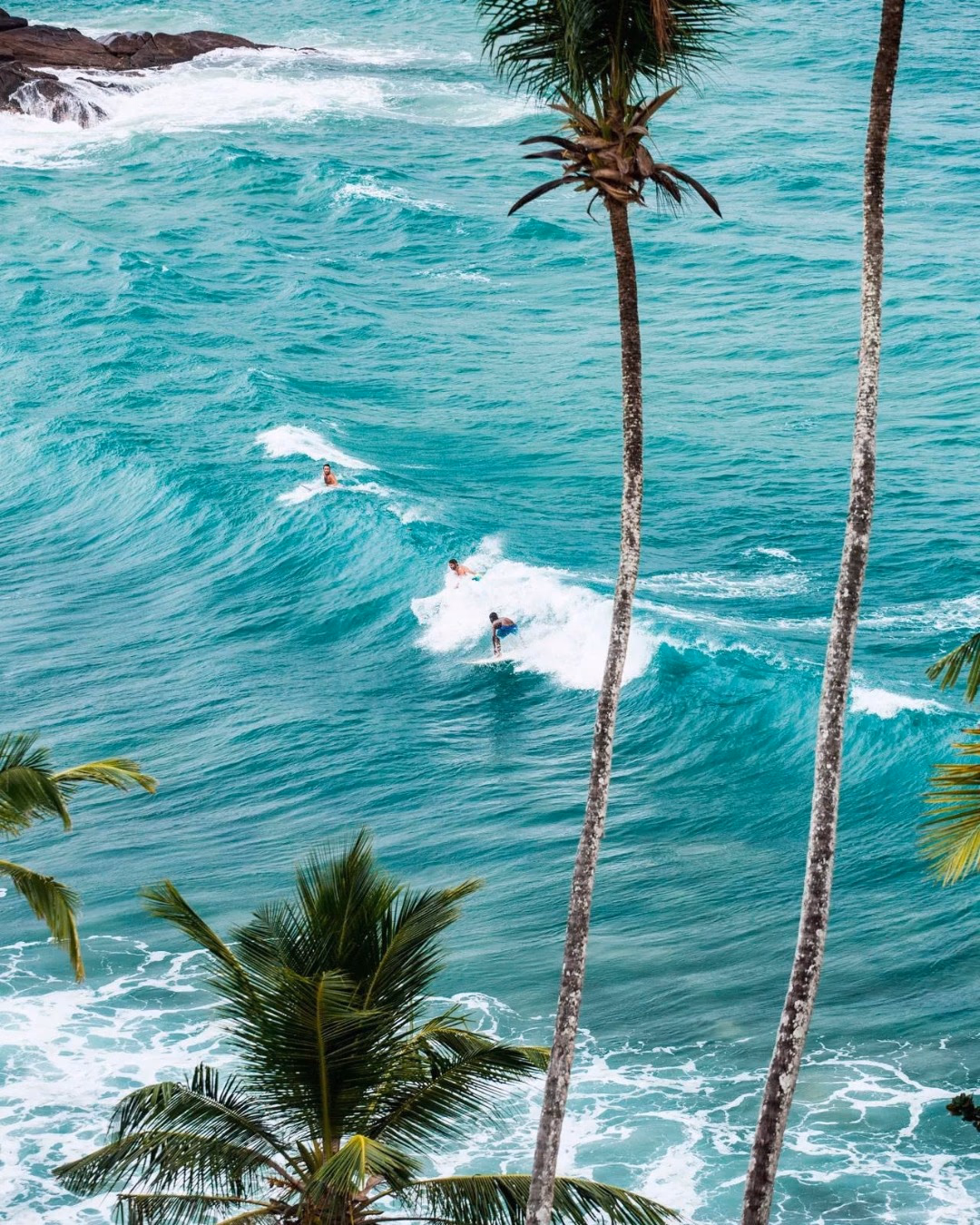 Surfer catching a wave at the renowned Kabalana Beach near K1 Villa.